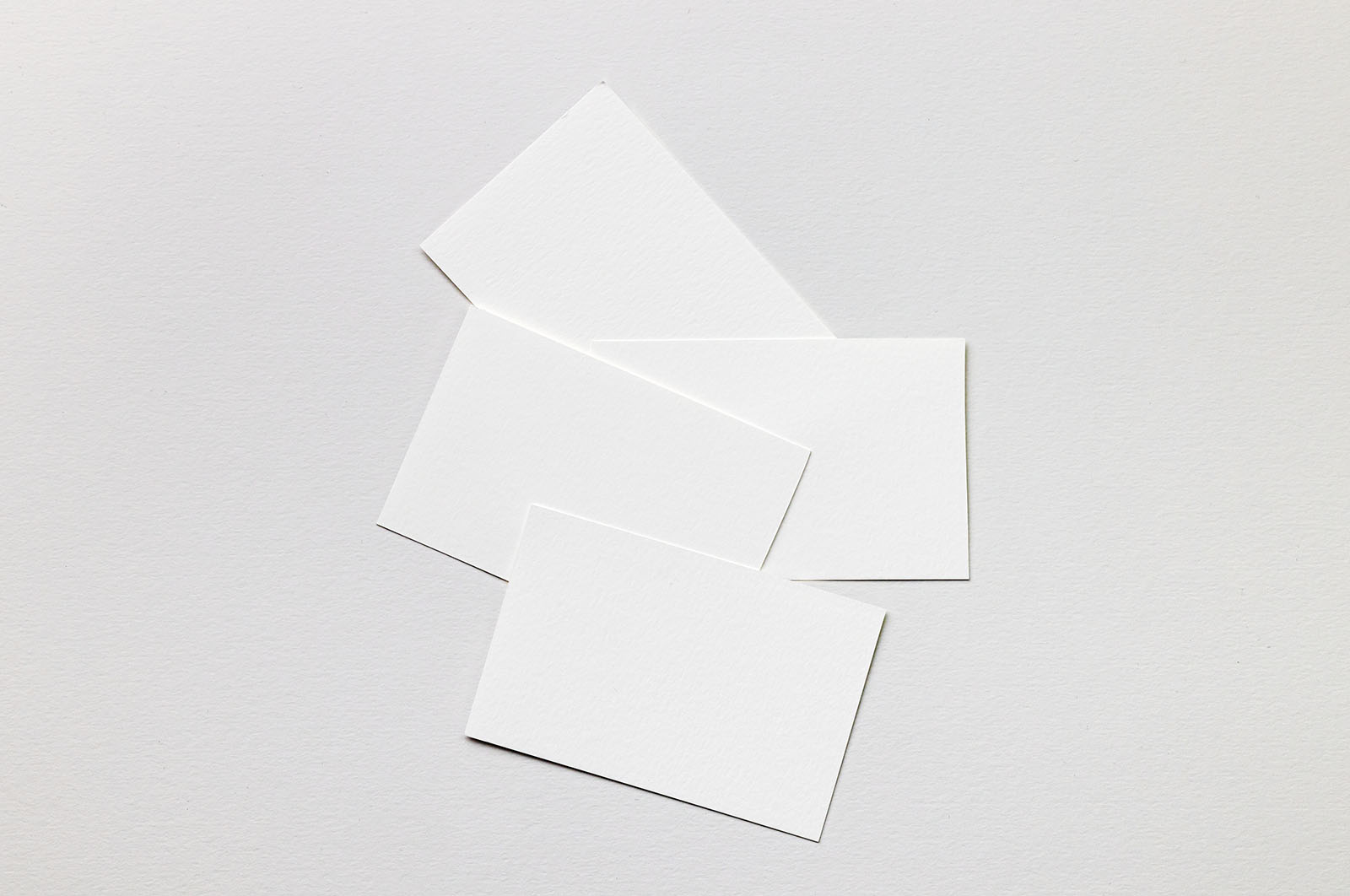 Few business cards lying on paper mockup