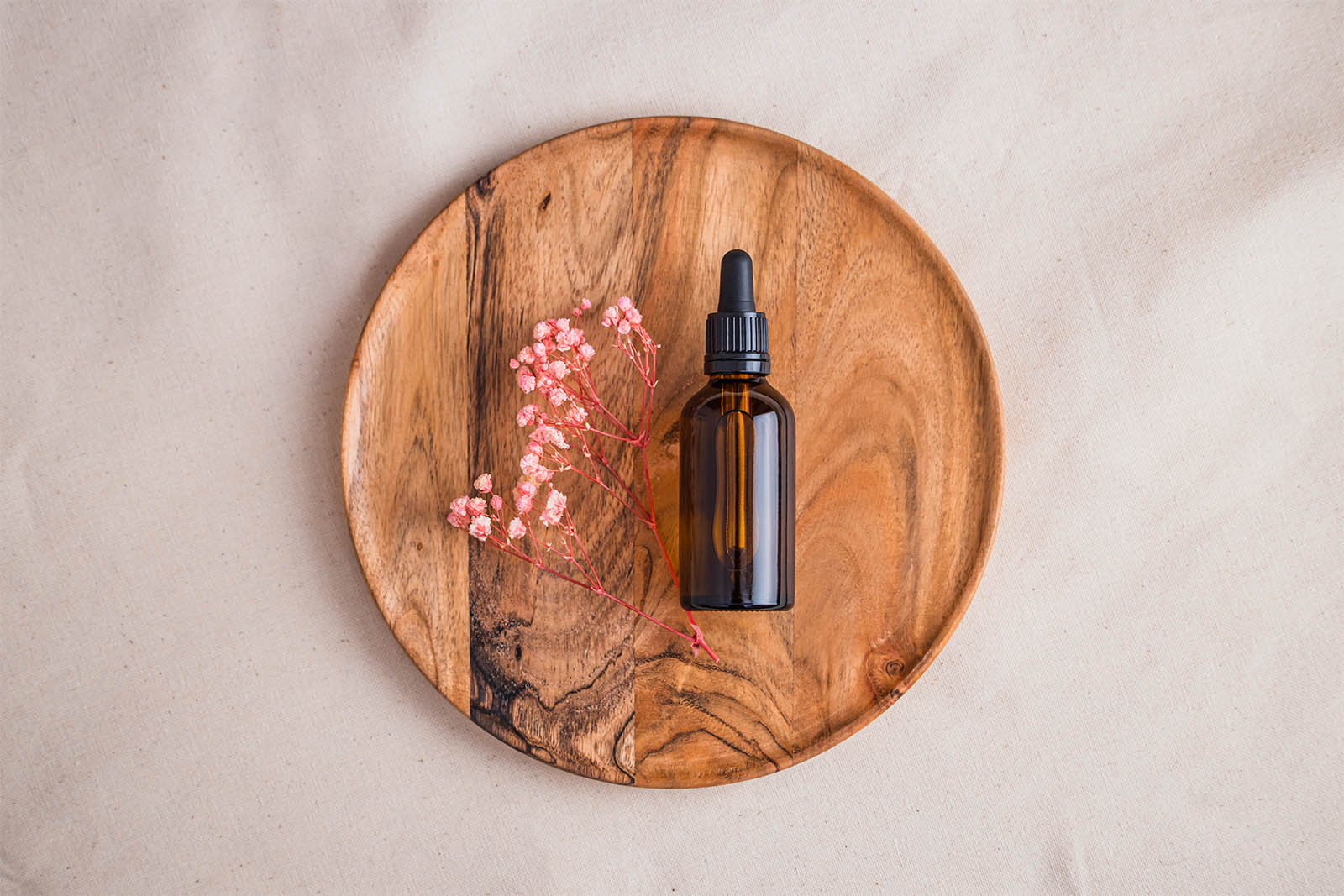 Amber bottle with dried flowers mockup