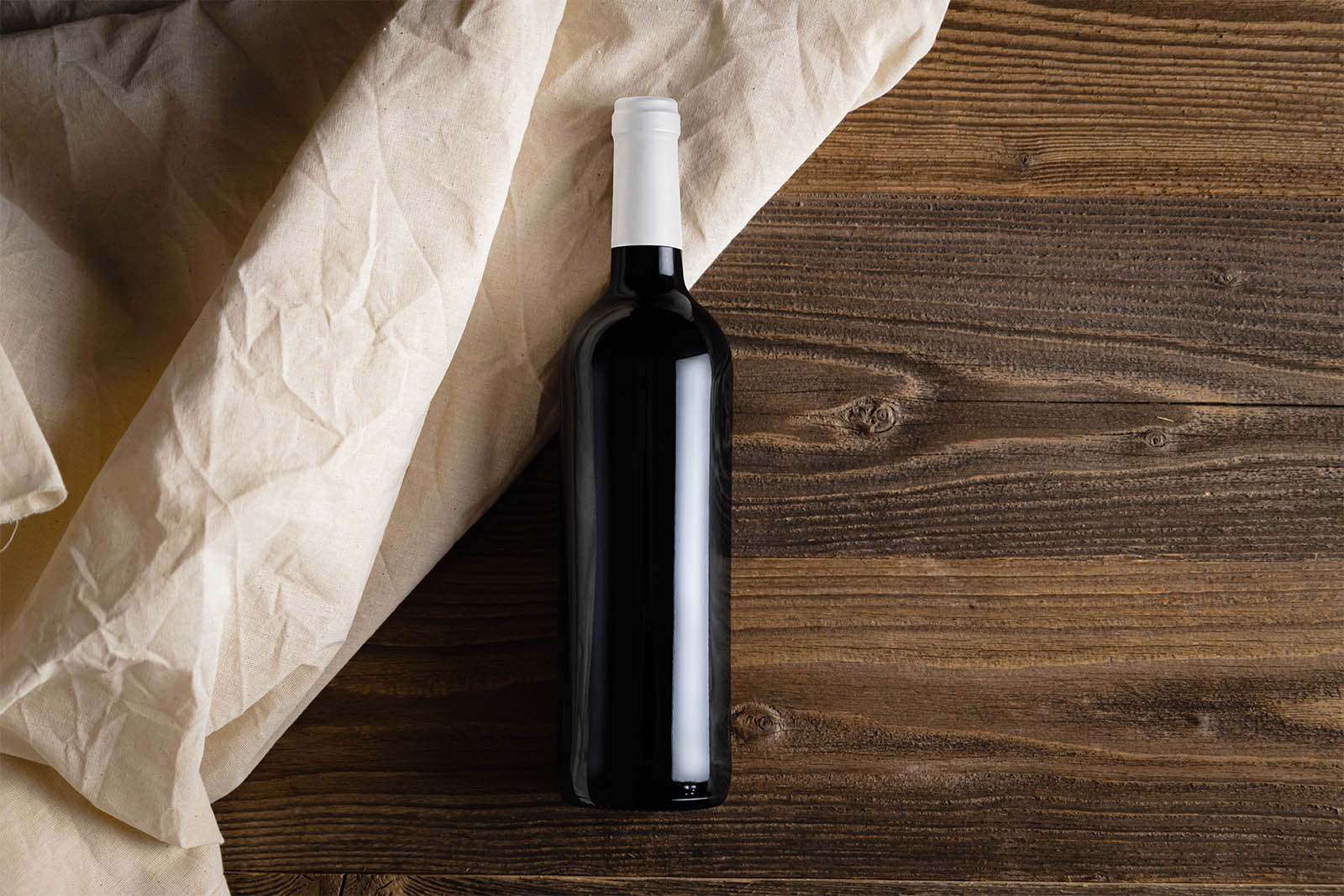 Wine bottle on wooden planks mockups