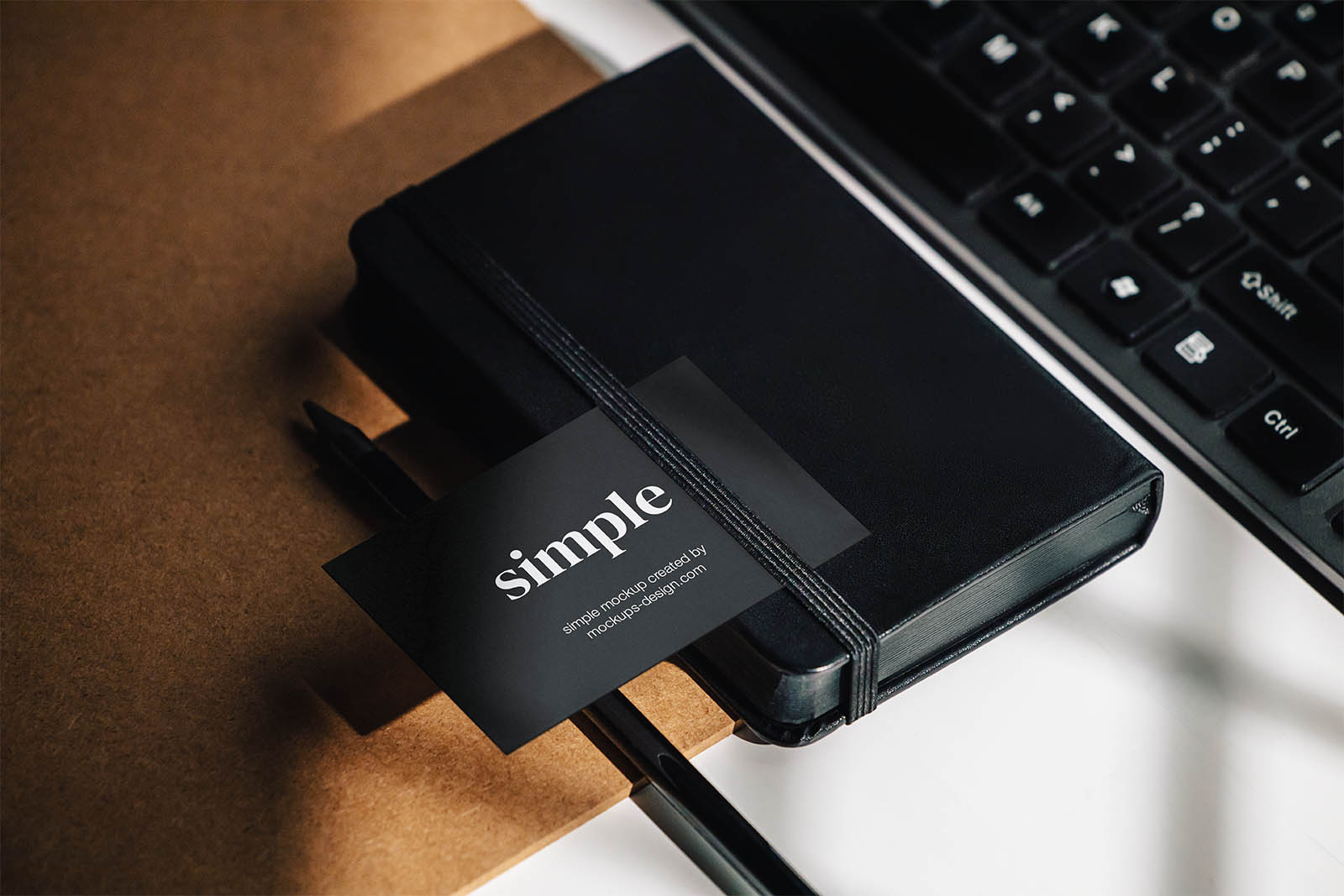 Business card on the black notepad mockup
