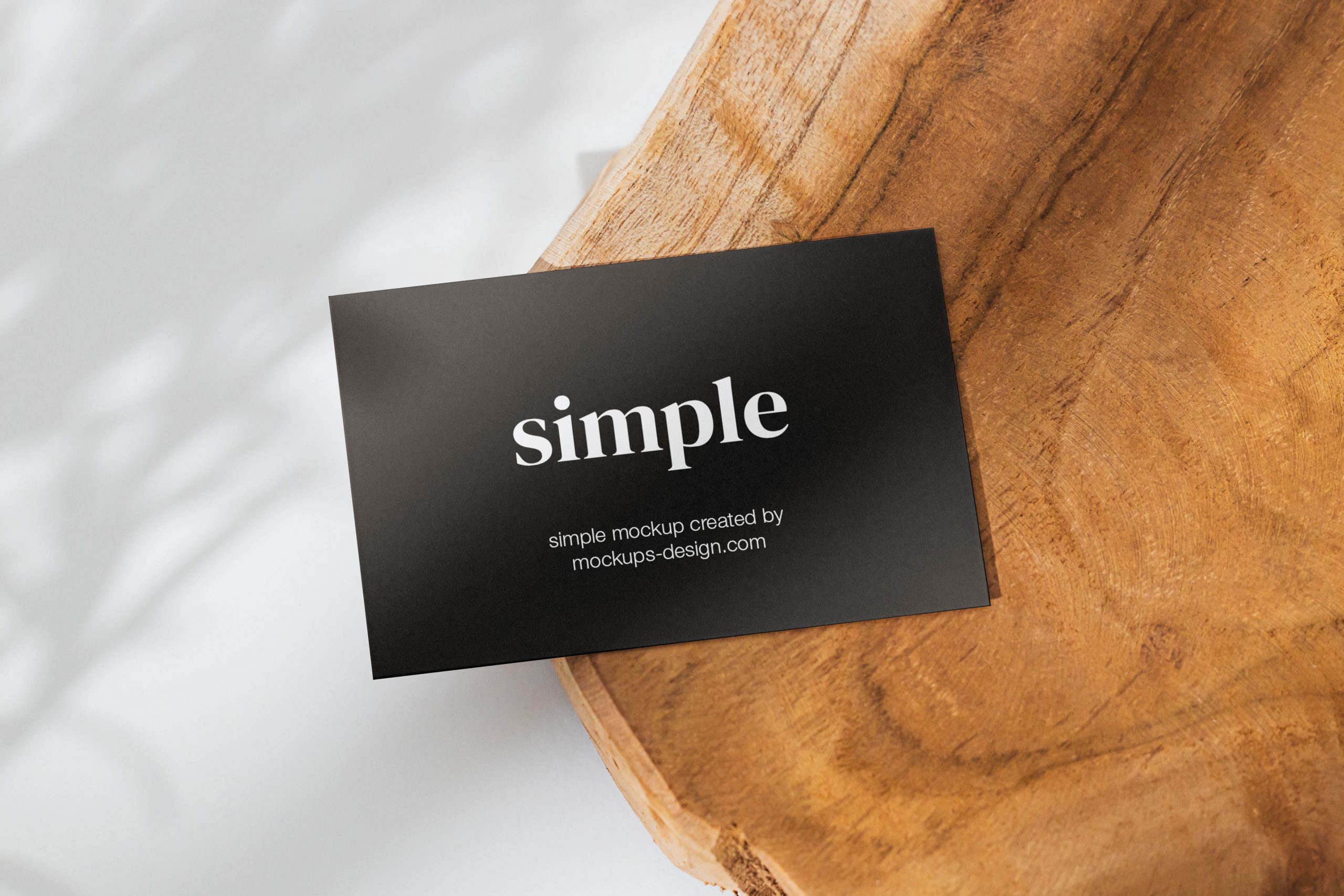 Business card on a slice of wood mockup
