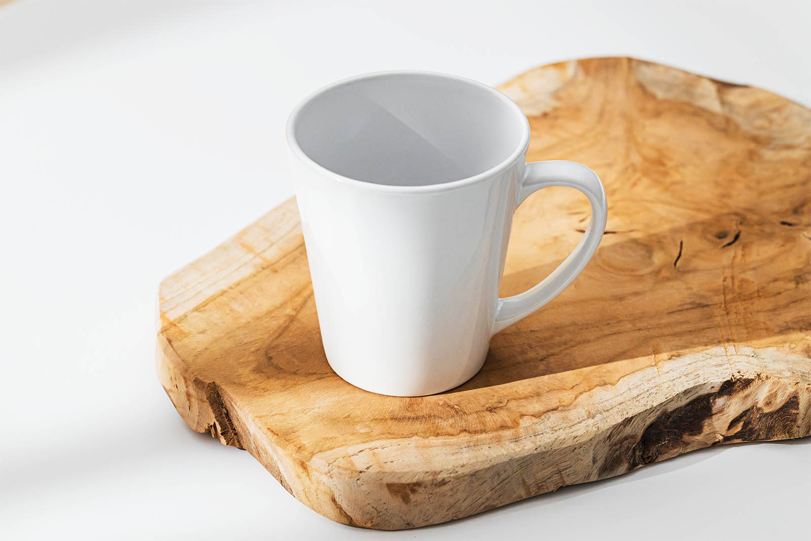 Ceramic mug on a slice of wood mockup