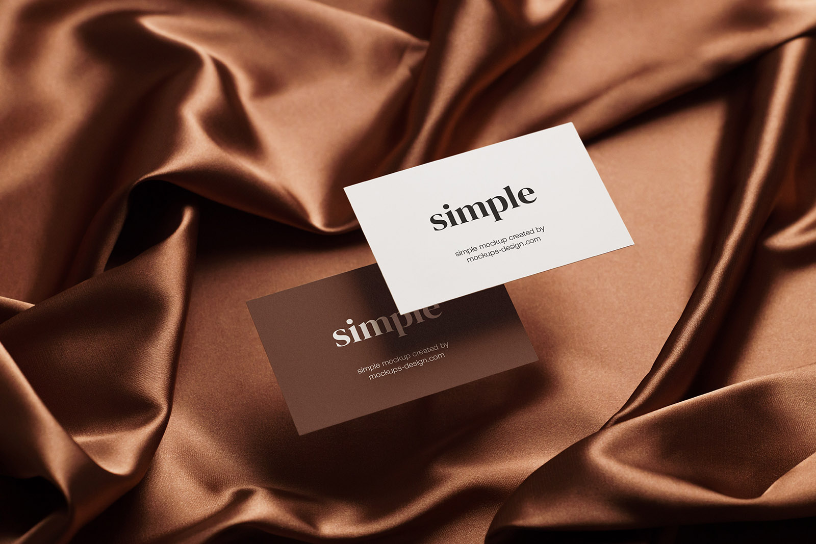 Two business cards on satin background mockup