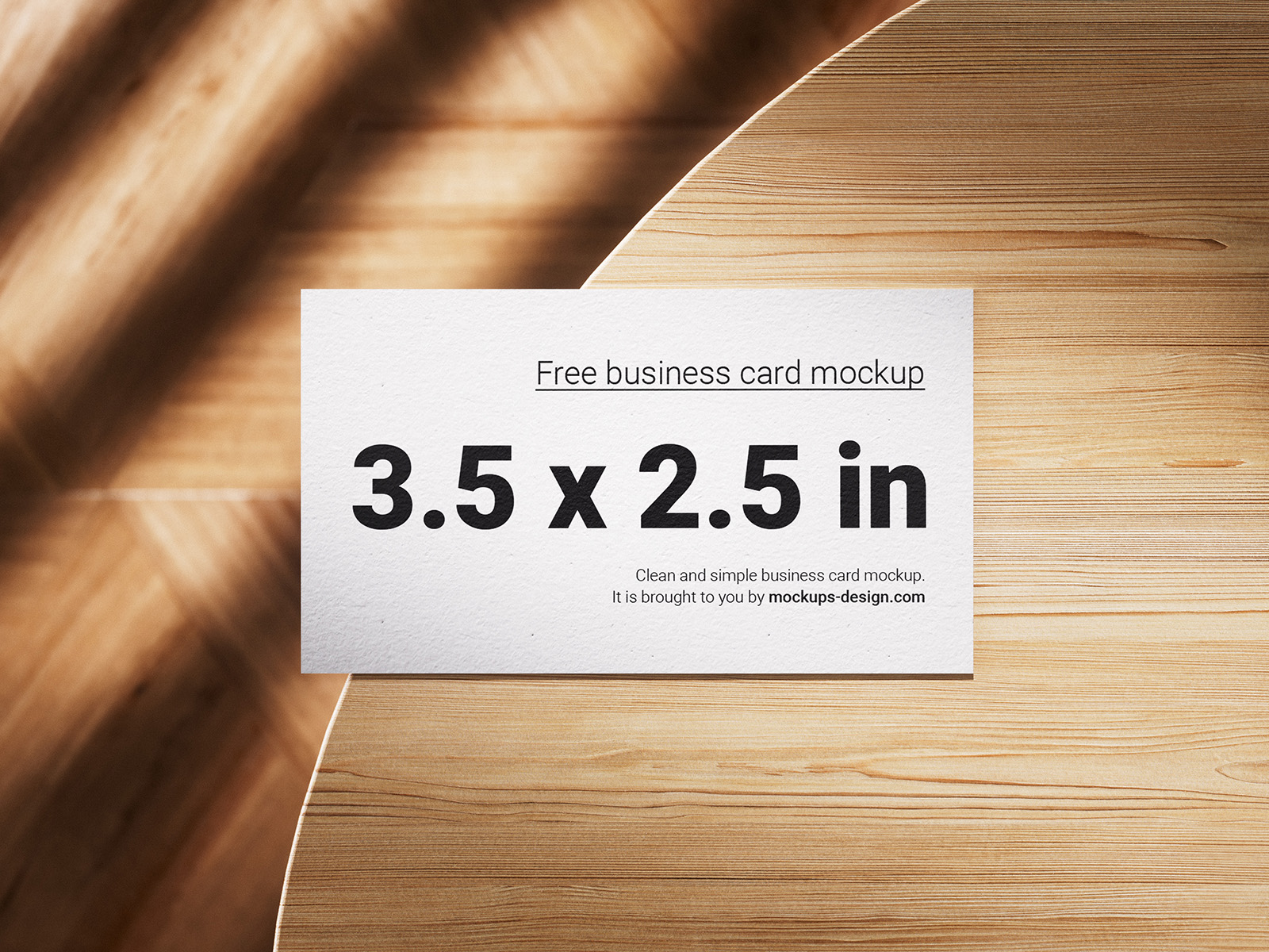 Business cards lying on a wooden table mockup